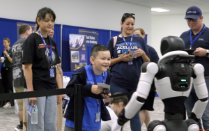Student Greets Robot at Acellus World